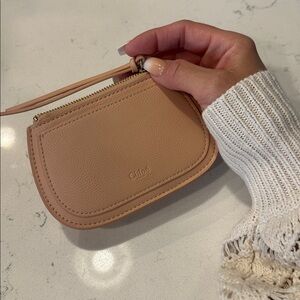 Tan Coin Purse with zipper and card slot.
